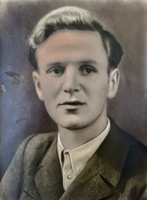 Studio portrait of Karl Fast as a young man, in a jacket and open-collared shirt